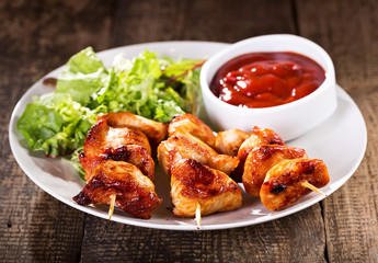 plate of grilled chicken with salad