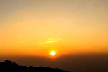 Fototapeta na wymiar Rising sun with golden sky over mountain