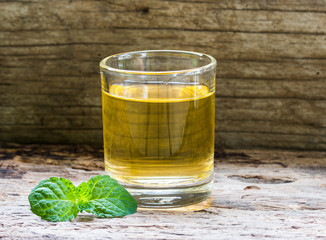 lemonade with mint on a dark wood background. tinting. selective