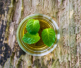 lemonade with mint on a dark wood background. tinting. selective