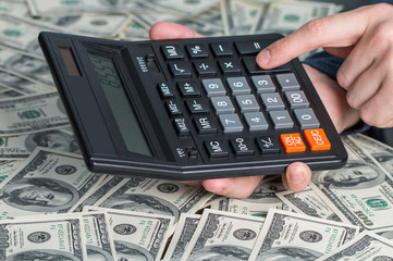 Man's hands with money and calculator