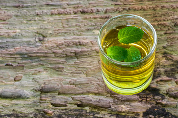 lemonade with mint on a dark wood background. tinting. selective