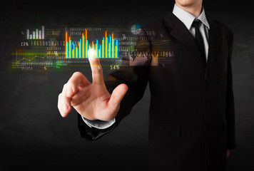 Young business person touching colorful charts and diagrams
