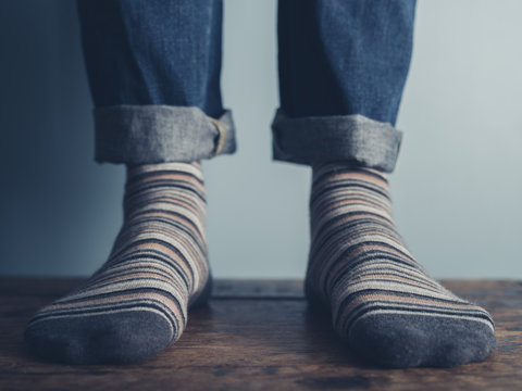 Feet Of A Man On Wooden Floor