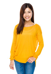Fototapeta premium Smiling cool asian girl with hands in her jeans pocket