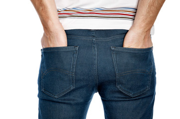 A man with his hands in jeans pockets