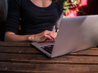 Fototapeta premium Woman using her laptop outside on balcony