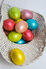 Easter colored eggs in a white basket