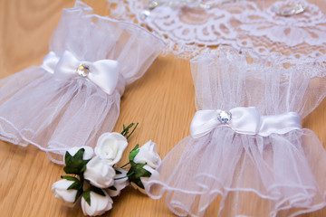 Delicate bride's gloves on the wooden background