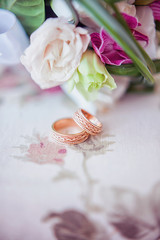 wedding rings on a vintage tablecloth