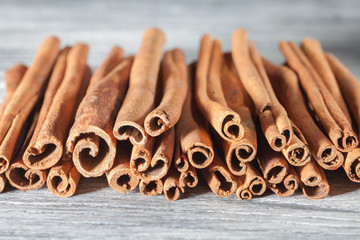 Cinnamon sticks isolated on white wooden table