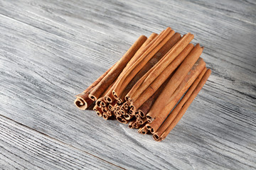 Cinnamon sticks isolated on white wooden table