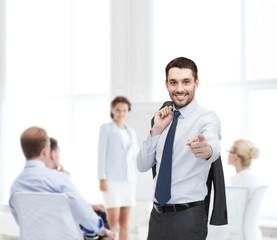 handsome buisnessman with jacket over shoulder