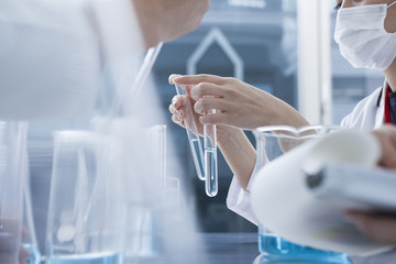 Women are comparing a test tube of both hands