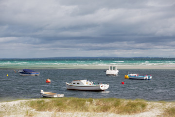 Obraz premium Group of small boats floating near the coast