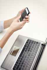 close up of woman texting on smartphone at office