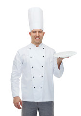 happy male chef cook showing empty plate