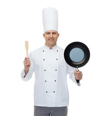 happy male chef holding frying pan and spatula