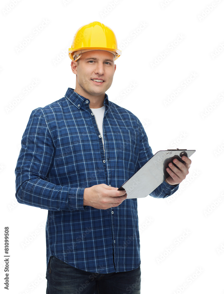 Wall mural smiling male builder in helmet with clipboard