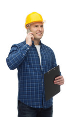 smiling male builder in helmet with clipboard