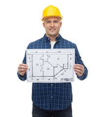 smiling male builder in helmet with blueprint