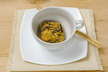 Dry instant noodles in white bowl with chopsticks