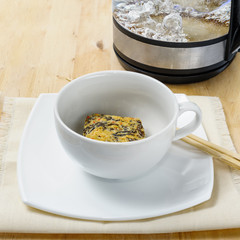 Dry instant noodles in white bowl with chopsticks