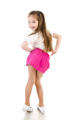 Adorable happy little girl posing back view isolated