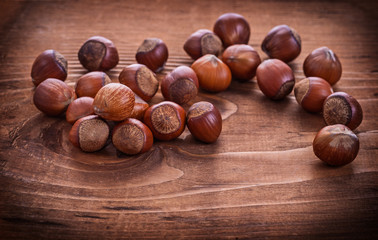 composition of hazelnuts on vintage wooden board food and drink