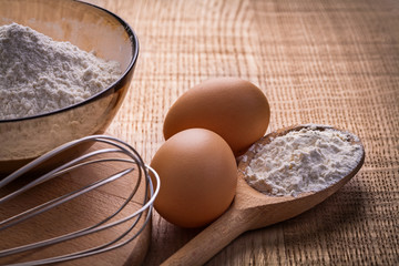 corolla eggs flour in spoon bowl  on wooden board food and d