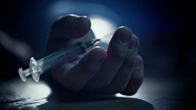 Junkie hand Fall to floor pricked heroin or meth drugs, drops