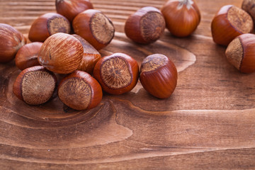 hazelnuts on vintage wooden board food and drink concept