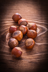 little heap of hazelnuts on vintage board food and drink concept