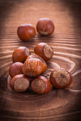 little heap of hazelnuts on vintage wooden board food and drink