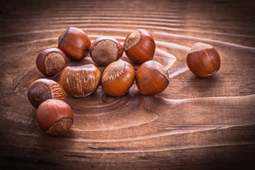 small heap of hazelnuts on vintage wooden board food and drink c