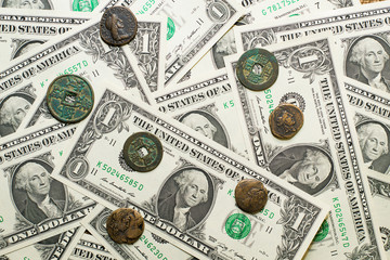 Antique  coins with portraits of emperors and banknotes of dolla