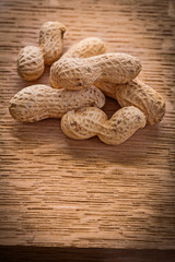 small stack of peanuts on vintage wooden board food and drink co