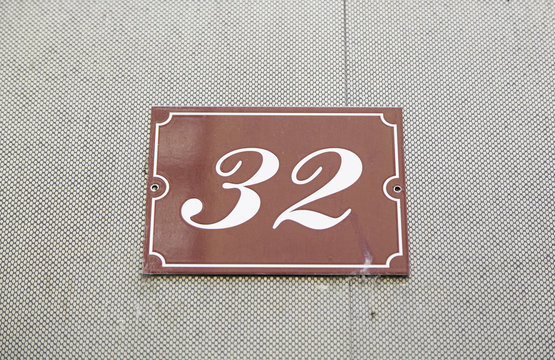 Number thirty-two on the wall of a house