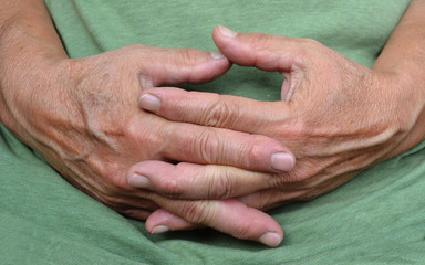 Resting hands of old woman
