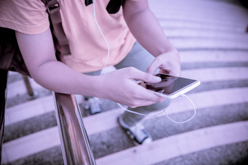 Fototapeta premium students sitting on stairs with their smartphones