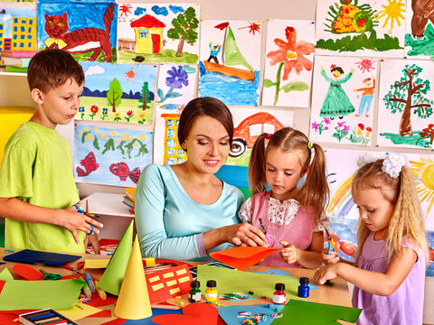 Children with teacher at classroom.