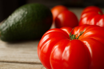 tomato with avocado and garlic with dill. on wood background