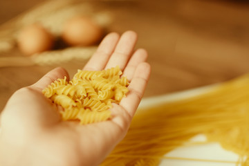 Female hand holding pasta