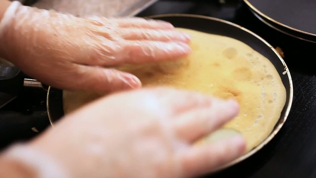flipping a pancake during frying in pan. Close up. Macro. HD
