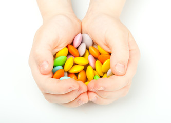 Child hands with colorful sweetmeats