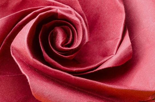 Abstract closeup of a realistic red paper origami rose flower