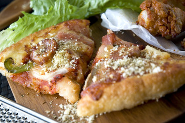 pieces of pizza with chicken wings