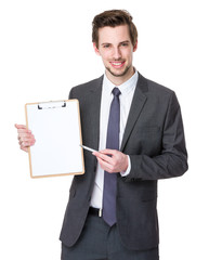 Happy smiling young business man showing blank clipboard