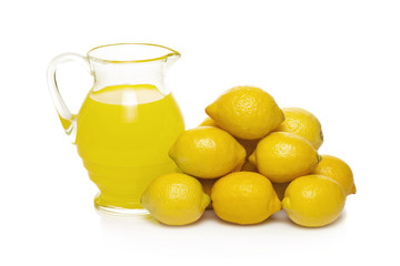 Lemon fruit juice in glass jug isolated on white