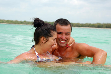 Cheerful couple swimming in the ocean
